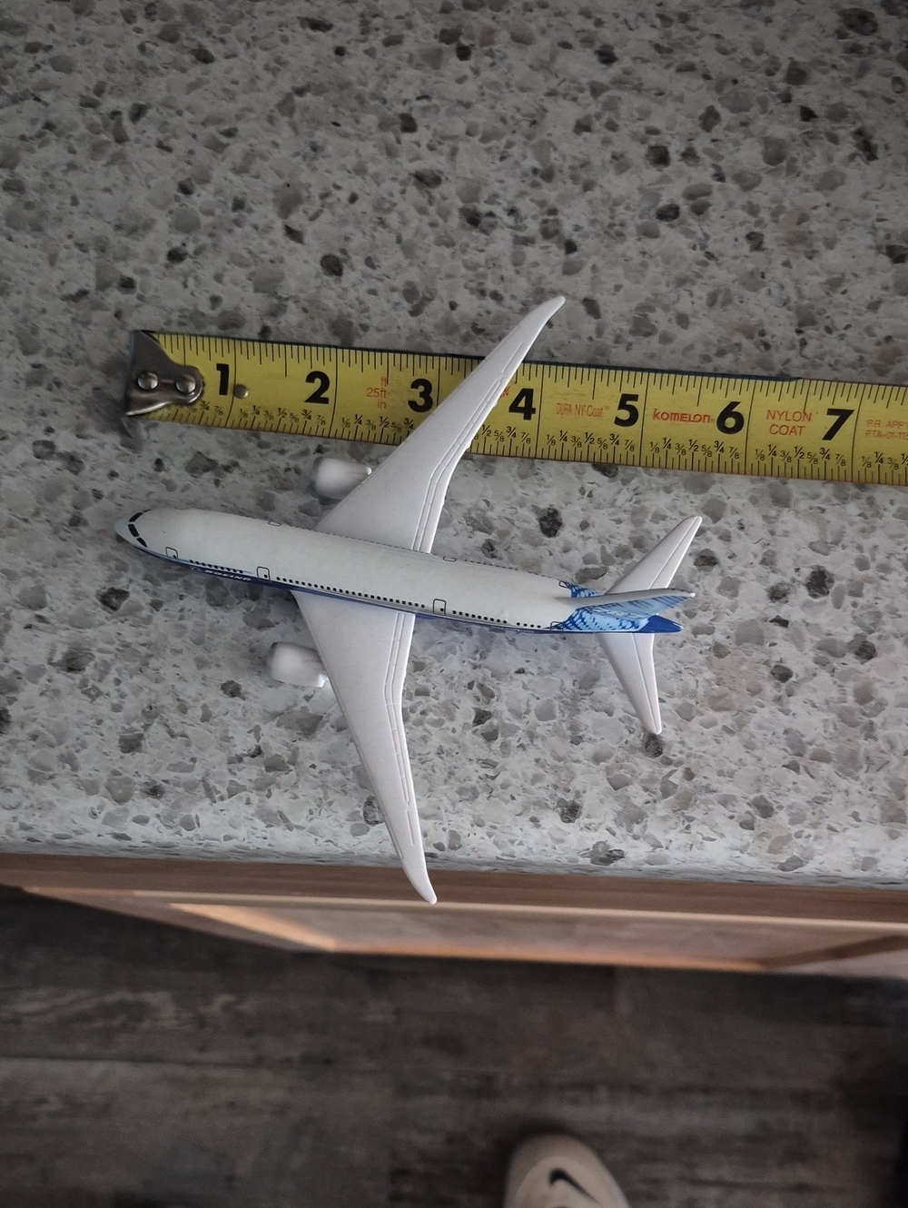 Diecast White Airplane Toy with Blue Tail Accent
